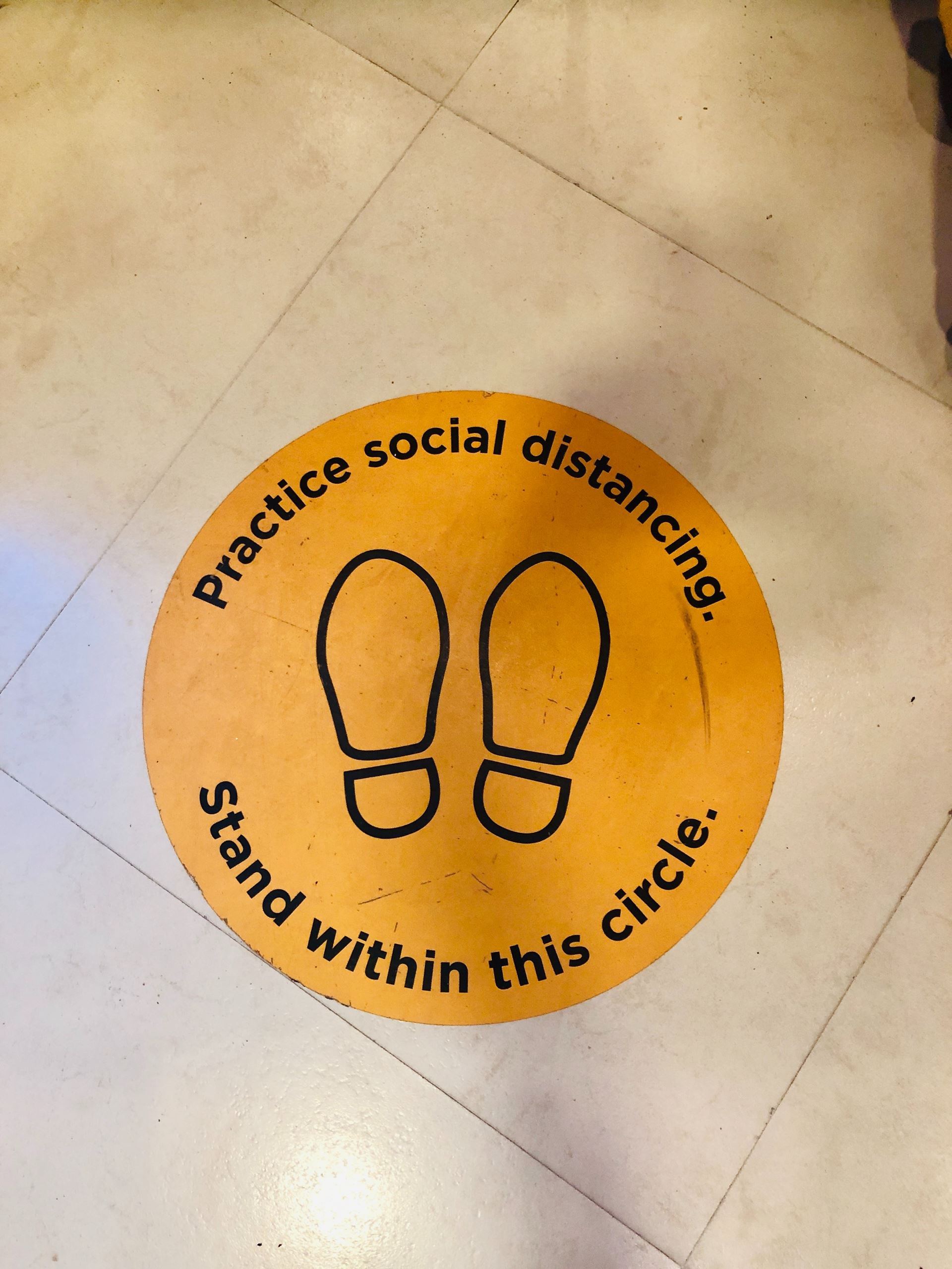 a floor marker reminding people to socially distance