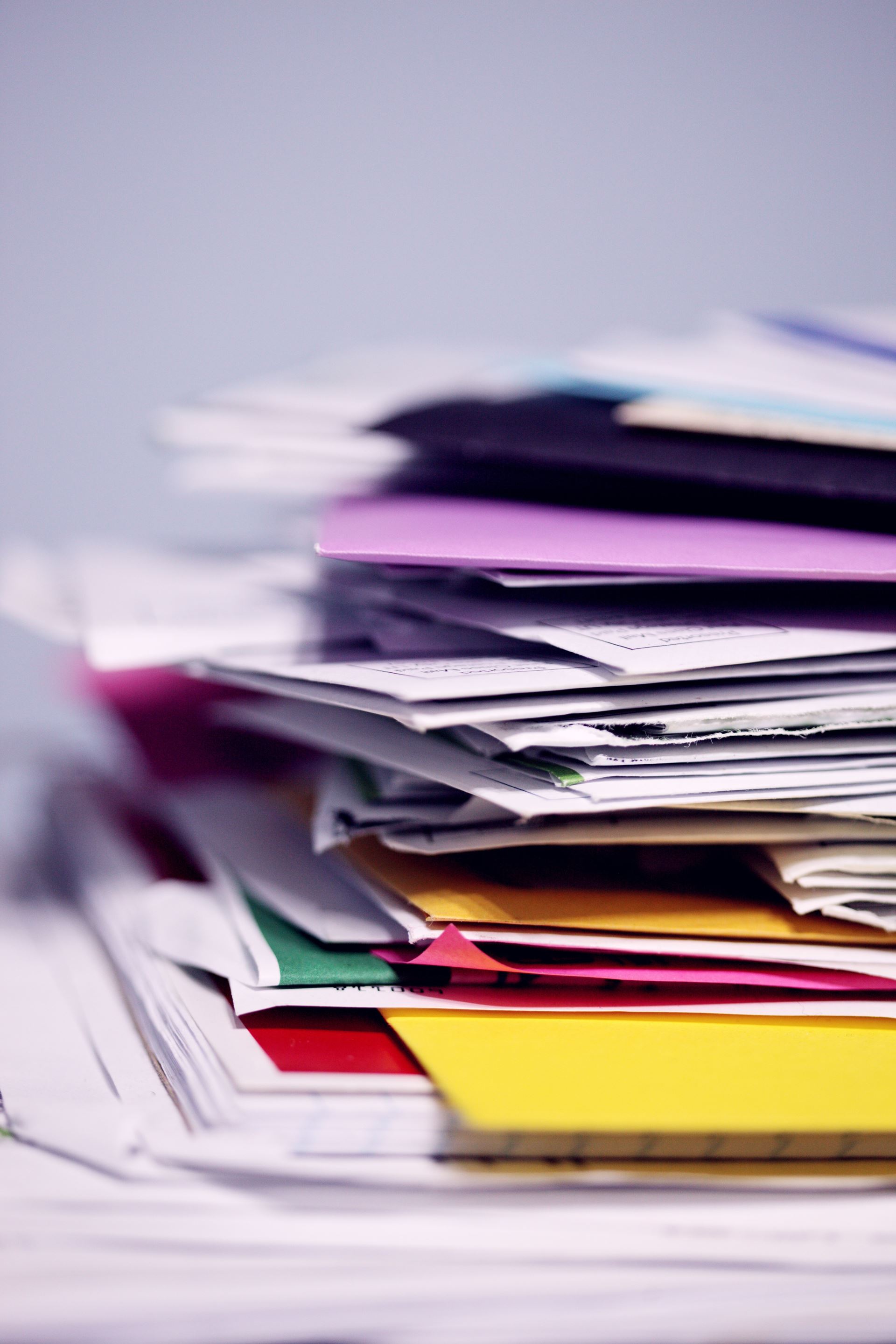 A purple folder with a selection of documents and letters inside