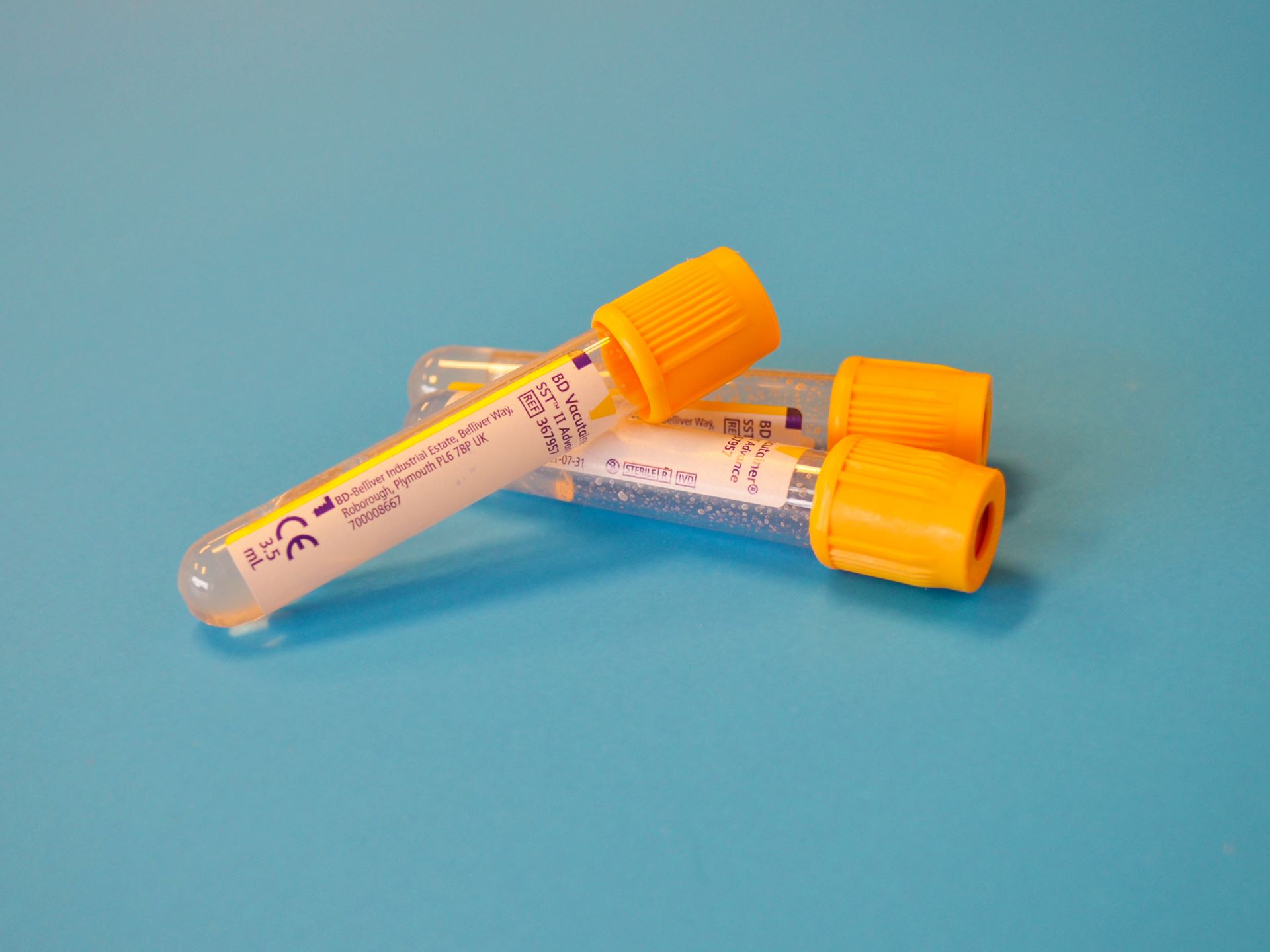 Three empty blood vials with yellow tops