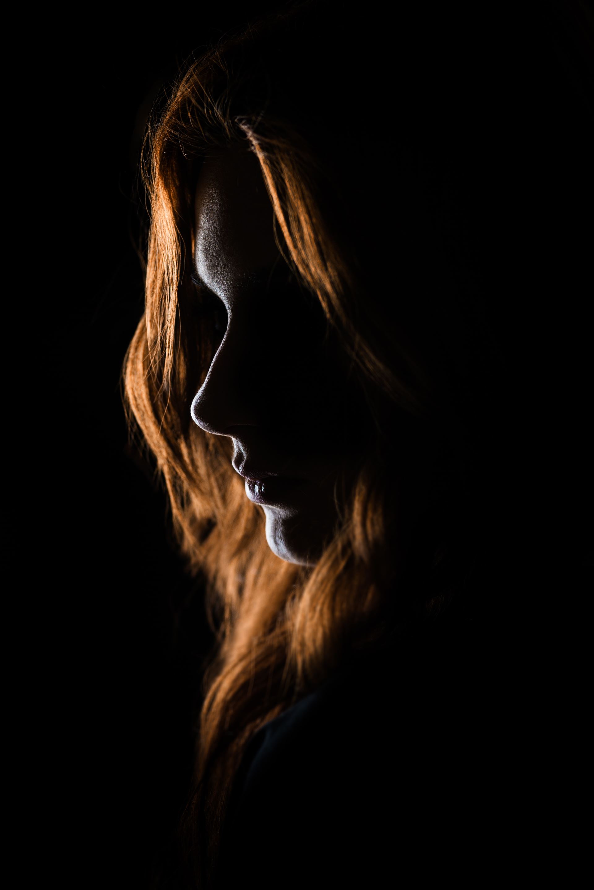 a silhouette of a woman in the dark