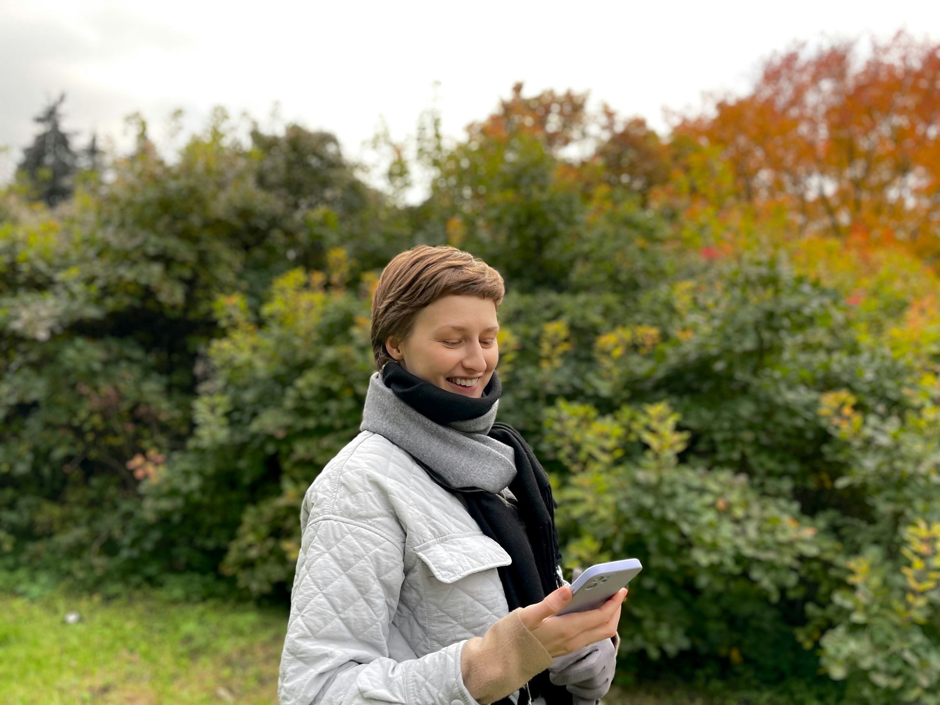 A person standing outside and looking at their phone