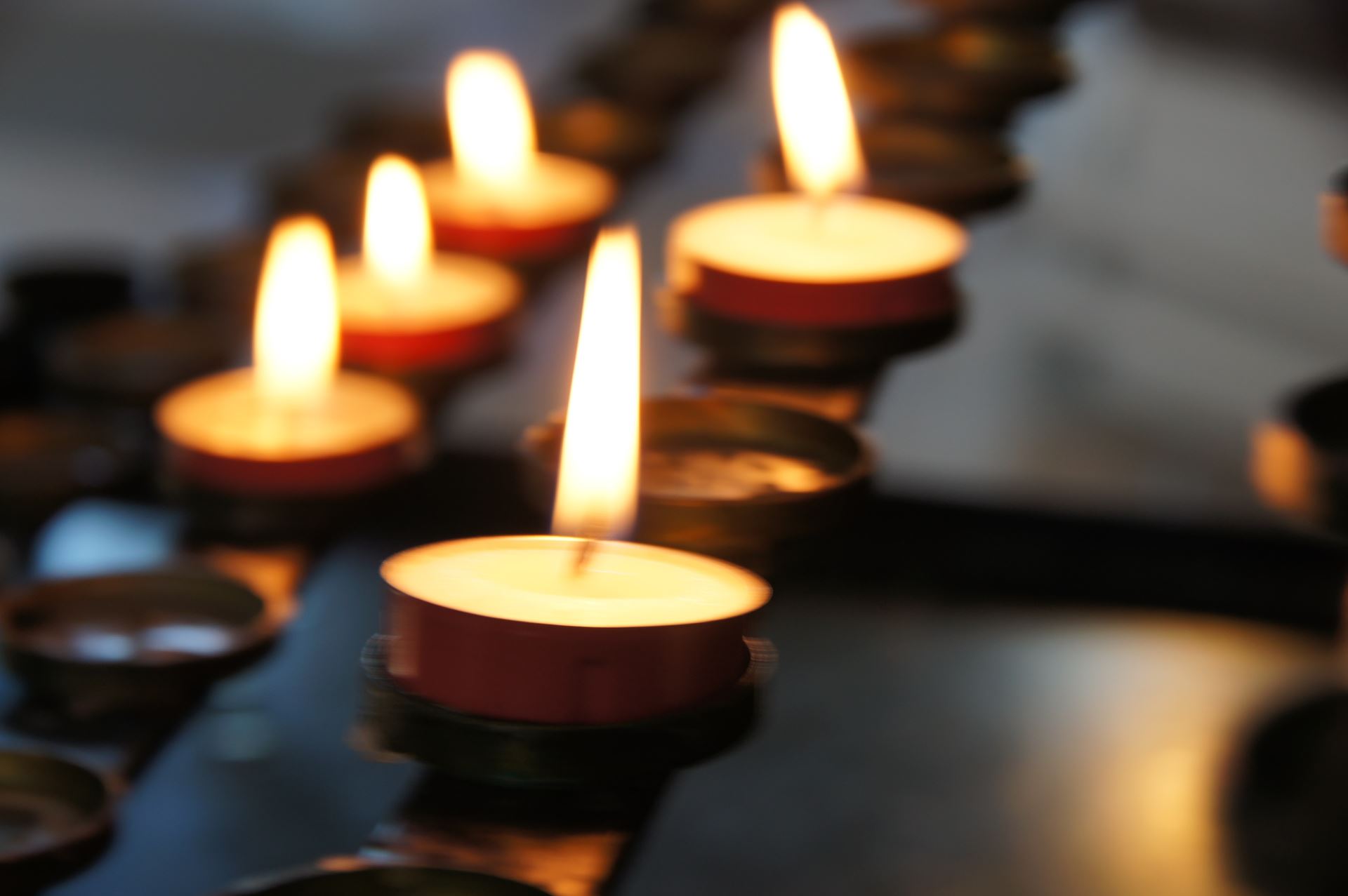 A selection of small tealight candles all lit